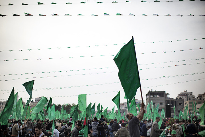 24 hours in pictures: A Palestinian man waves a green Hamas party flag