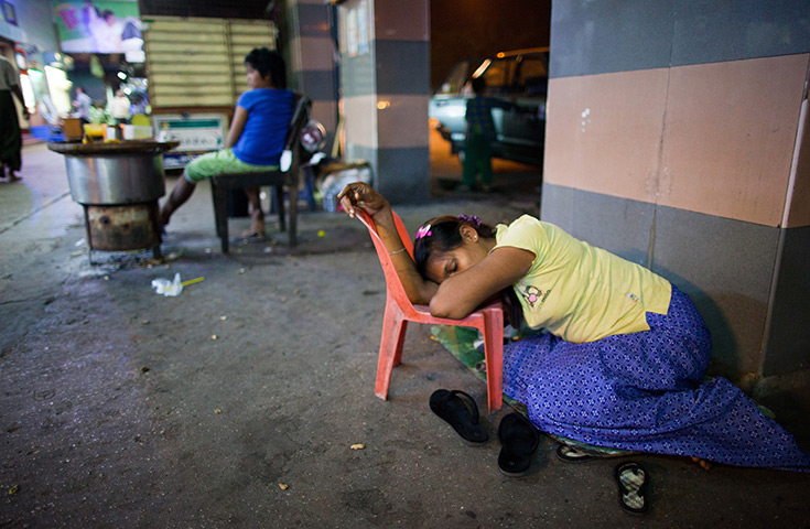 24 hours in pictures: A vendor sleeps on a street in Burma