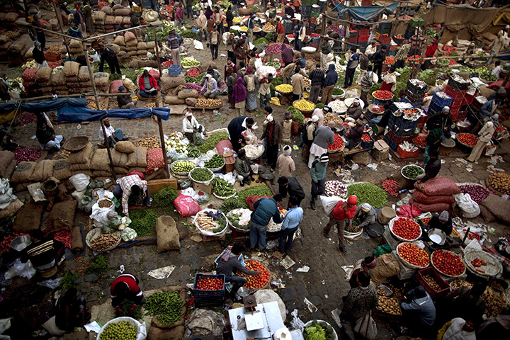 24 hours in pictures: Indians buy and sell vegetables at a market in New Delhi