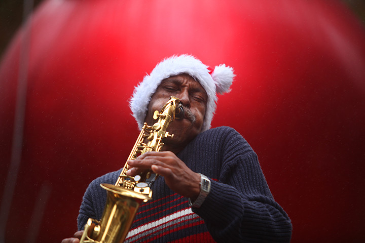 24 hours in pictures: Sax Player entertains pedestrians with Christmas Carols, Dallas