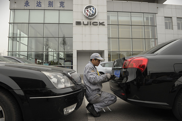 Week in Business: A mechanic works on a Buick at a General Motors (GM) dealership in Shanghai