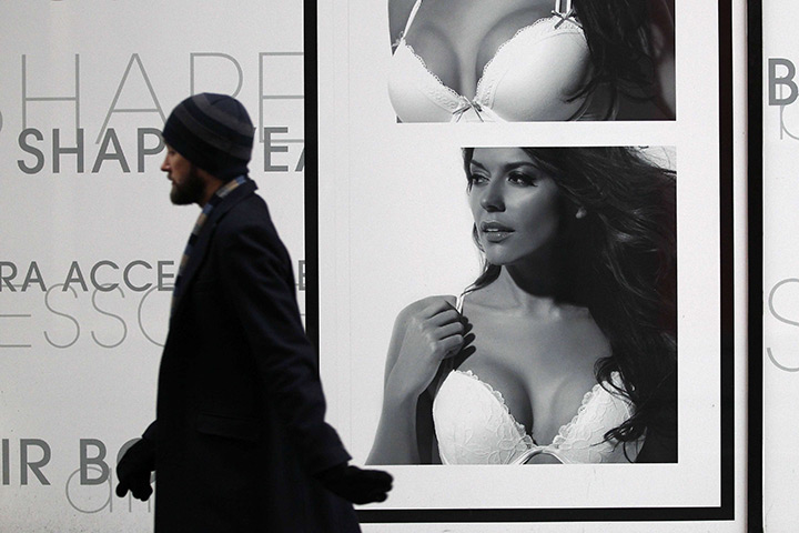 Week in Business: A man passes a La Senza lingerie advertisement in London