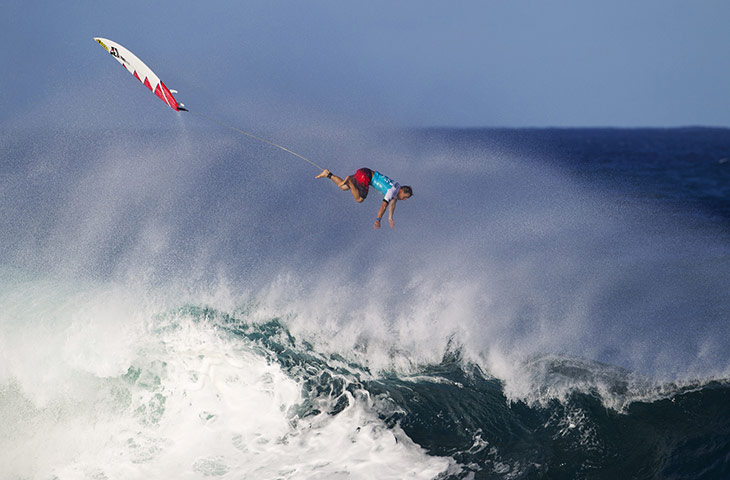 Best of the sport week: Kalani Chapman of Hawaii flies through the air as he exits a wave
