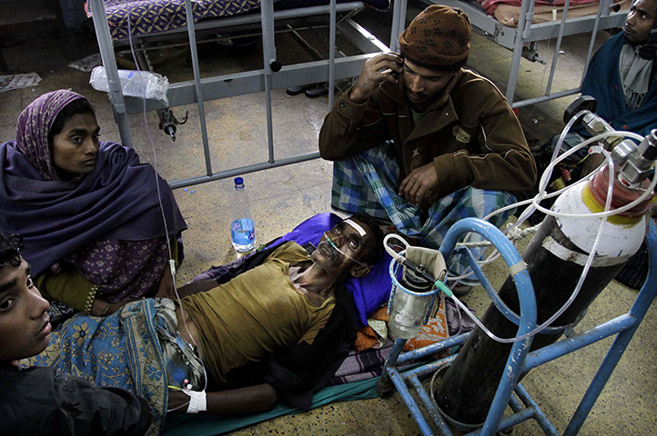 24 hours in pictures: Diamond Harbour, India; A patient is surrounded by relatives