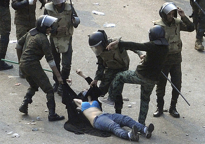 Tahrir Square clashes: Egyptian army soldiers beat a female protester at Tahrir Square 