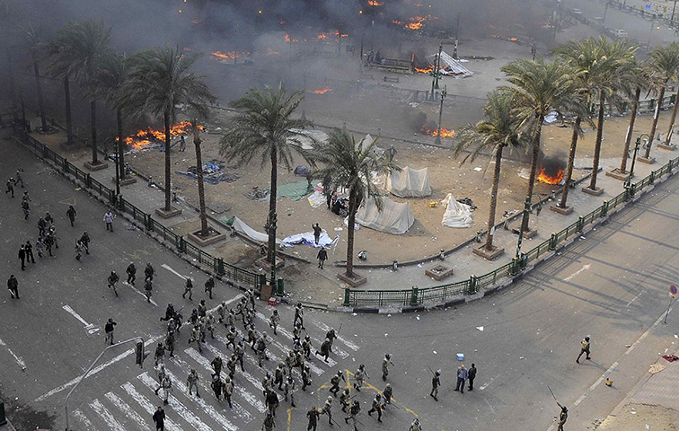 Tahrir Square clashes: Egyptian army soldiers run during clashes at Tahrir Square
