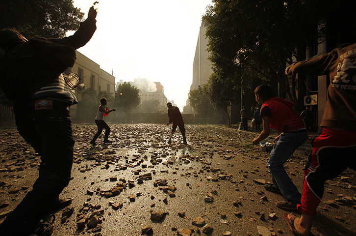 Tahrir Square clashes: Protestors throw stones during clashes with security forces