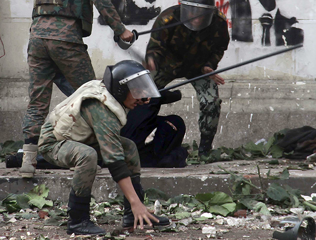 Tahrir Square clashes: Egyptian army soldiers rear arrest a woman protester wearing the Niqab