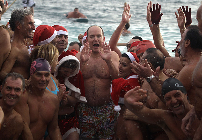 24hours in pictures: Prince Albert II of Monaco poses with swimmers in the Mediterranean sea