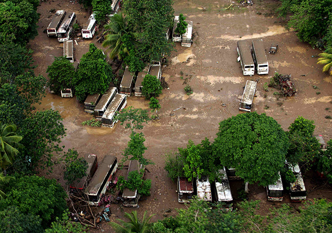 Philippines flooding: Buses covered with mud in the southern island of Mindanao