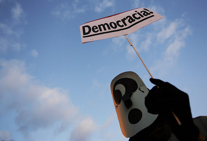 24 hours: Madrid, Spain: A protester wearing a mask with an question mark