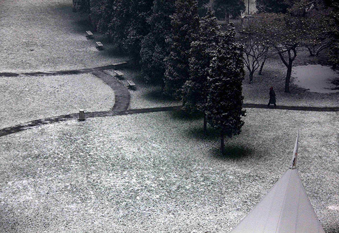 24 hours in pictures: Beijing, China: A security guard carries a hot water flask