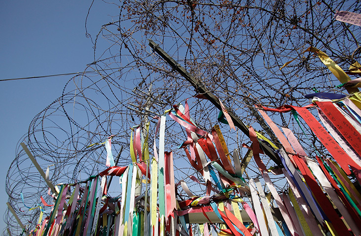 Kim Jong-il lies in state: Pro-unification messages hang on the barbed wire, Paju, South Korea