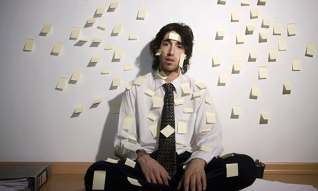 Businessman covered in sticky notes