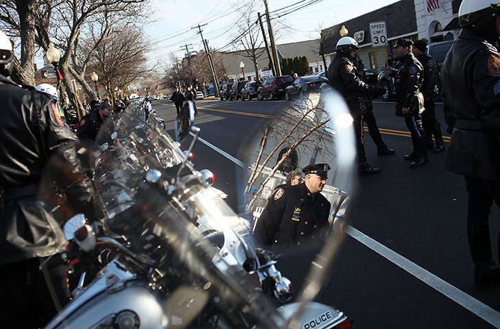 24 hours in pictures: Police officers attend the funeral of New York City Police officer