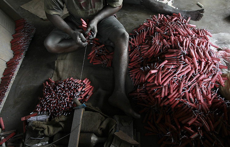 24 hours in pictures: An employee makes firecrackers at a factory in Katunayake