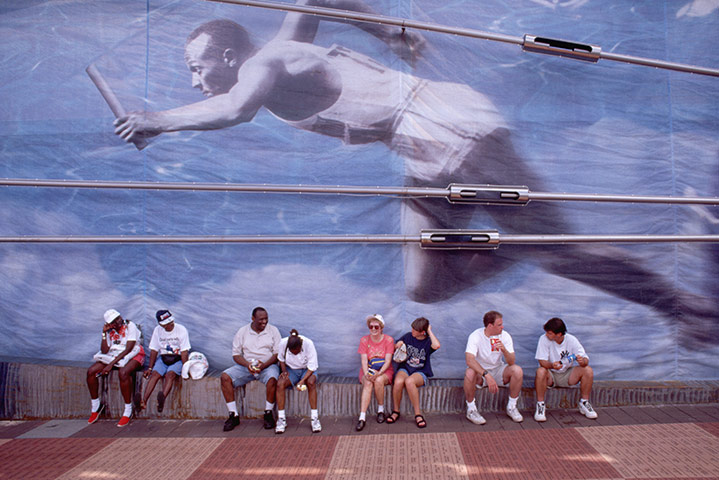 Jesse Owen: People sit under mural of Jesse Owens