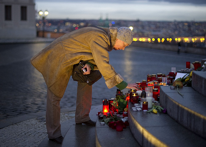 Vaclav Havel funeral: A woman places a candle on a makeshift memorial on the route of the hearse