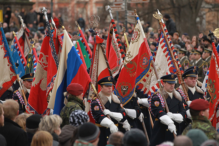 Vaclav Havel funeral: An honour guard bears standards as the coffin is brought to Prague Castle