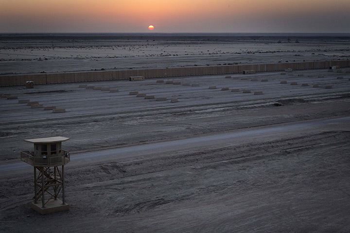 FTA: Lucas Jackson: The sun sets behind an empty staging area in Camp Adder 