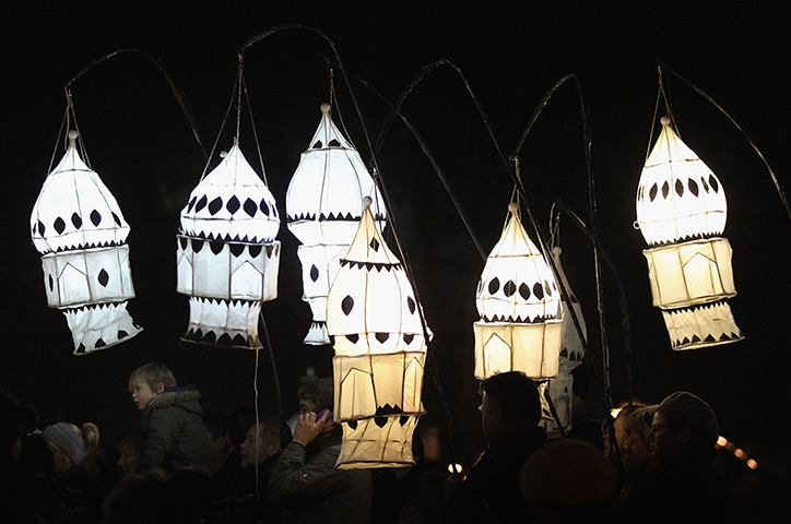 24 hours in pictures: Brighton, UK:  People carry lanterns at the Burning The Clocks Festival