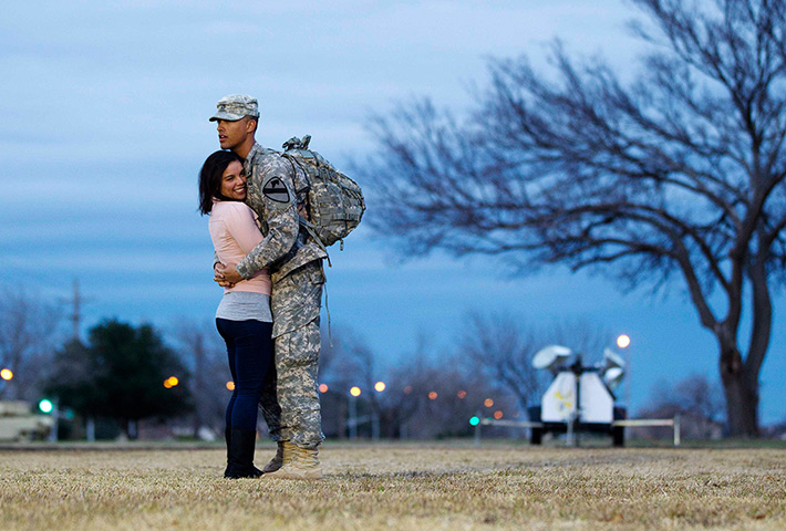 24 hours in pictures: Fort Hood, US: Private Devin Alderman hugs his girlfriend