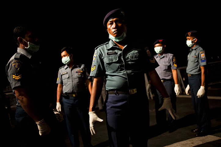 24 hours in pictures: Banyuwangi, East Java: Sailors from the Indonesian Navy stand guard