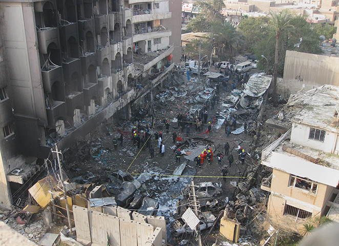 Iraq bombing: Iraqi security forces gather the scene of a car bomb attack in Baghdad