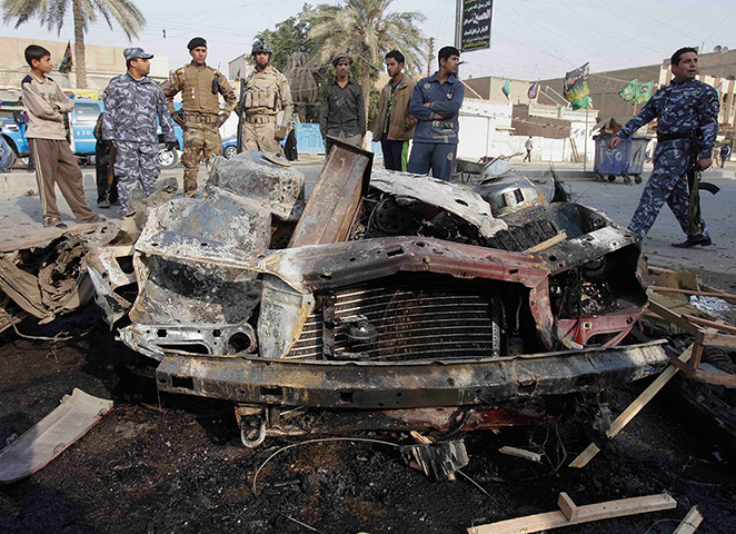 Iraq bombing: Iraqi security forces and people gather the scene of car bomb attack, Iraq