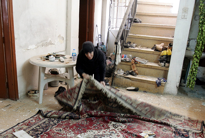 Iraq bombing: An Iraqi woman inspects damage in her house at Karada district