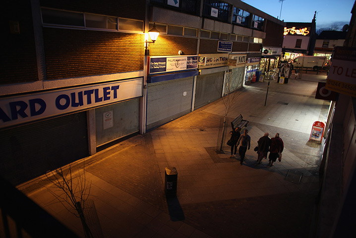 Week in Business: People walk by boarded up shops in Altrincham
