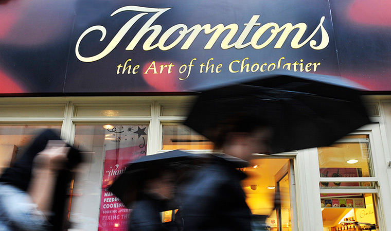 Week in Business: Pedestrians pass a Thorntons chocolate store 