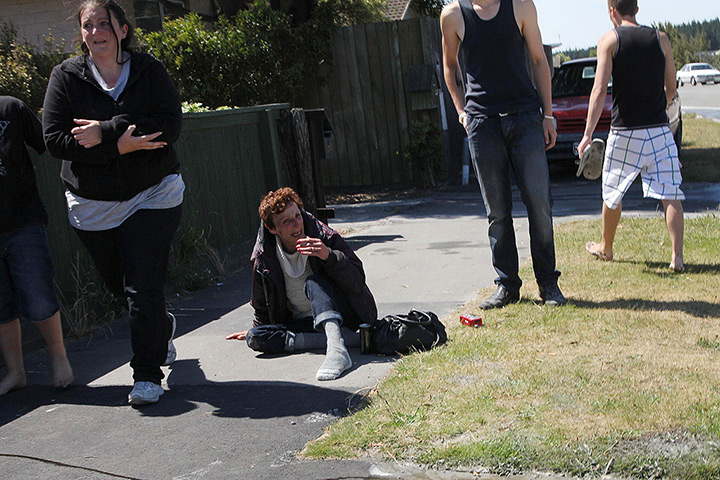 Christchurch earthquake: Local residents sit on the footpath the earthquake