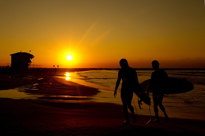 24 hours in pictures: Netanya, Isreal: Surfers walk on the beach