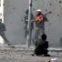g2 pictures of the year: Libyan rebel plays a guitar in Sirte