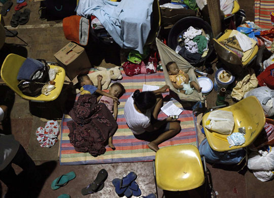 24 hours in pictures: Iligan City, Philippines: Flood victims inside a gymnasium turned into an evacuation centre