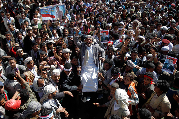24 hours in pictures: An anti-government protester on a wheelchair is carried in Sana'a