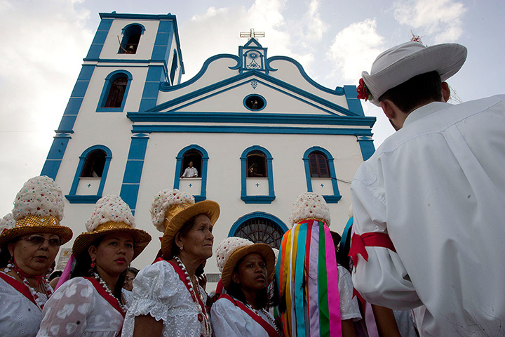 24 hours in pictures: Catholic faithful wear the typical dress of a 