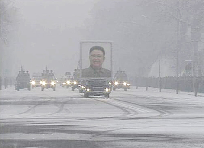 Kim Jong-il funeral: The funeral procession moves past crowds on a street in Pyongyang