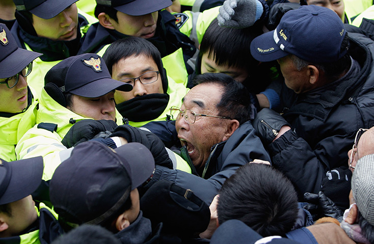 24 hours in pictures: Seoul: Activists try to enter the office of pro-unification group