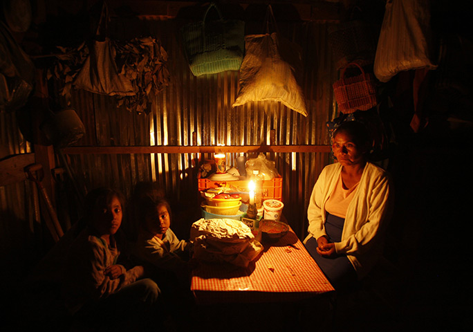 24 hours in pictures: Oaxaca, Mexico: A woman sits with her grandchildren at their home