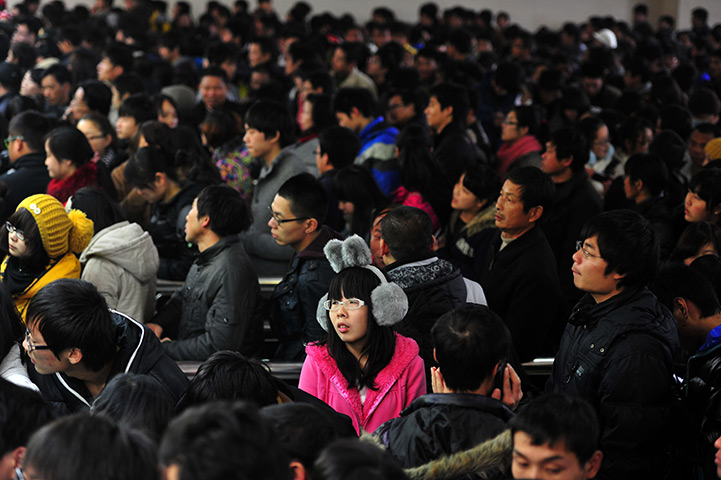 24 hours in pictures: Changsha, China: People queue to buy train tickets
