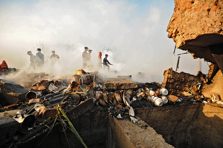 24 hours in pictures: Yangon, China: Fireman work at the site of an explosion in a warehouse