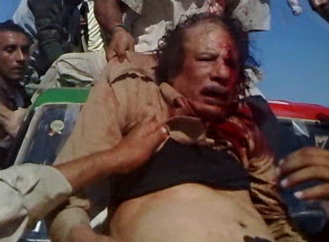 Camera phones: 20 October 2011: An NTC fighter pulls Muammar Gaddafi onto a vehicle