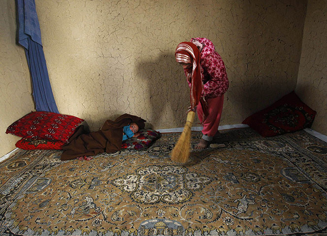 24 Hours: a girl sweeps her home in the old part of Kabul