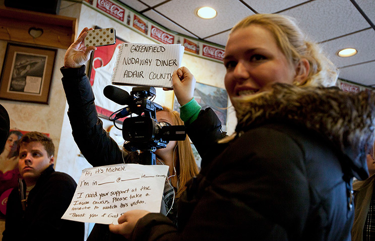 Iowa campaigning: Members of Rep. Michele Bachmann's, R-Minn. campaign team hold a sign