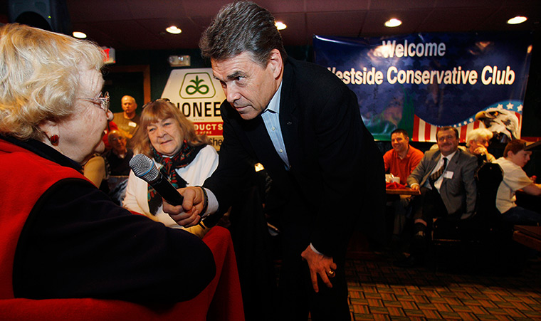 Iowa campaigning: Rick Perry listens to a question at Westside Conservative Club breakfast