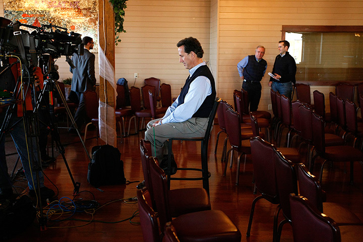 Iowa campaigning: Rick Santorum waits to give a television interview in Muscatine