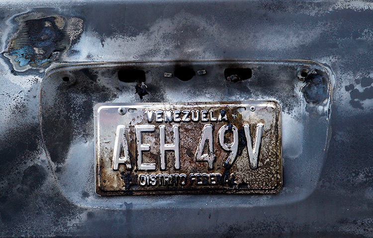 24 hours : Caracas, Venezuela: A plate of a burned-out car at the scene of an accident