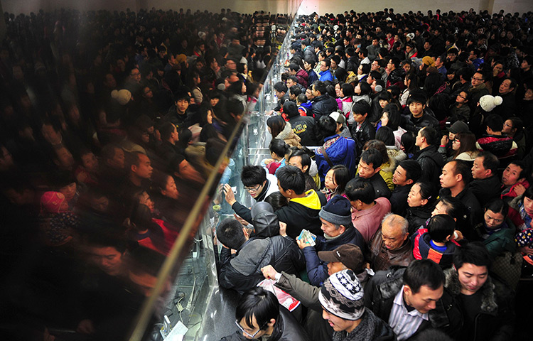24 hours : Changsha, China: People queue up to buy train tickets at a railway station